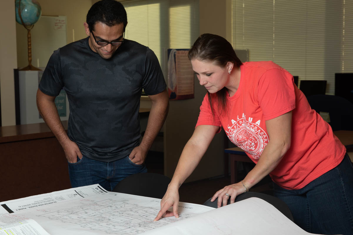 Man and woman reading building plans